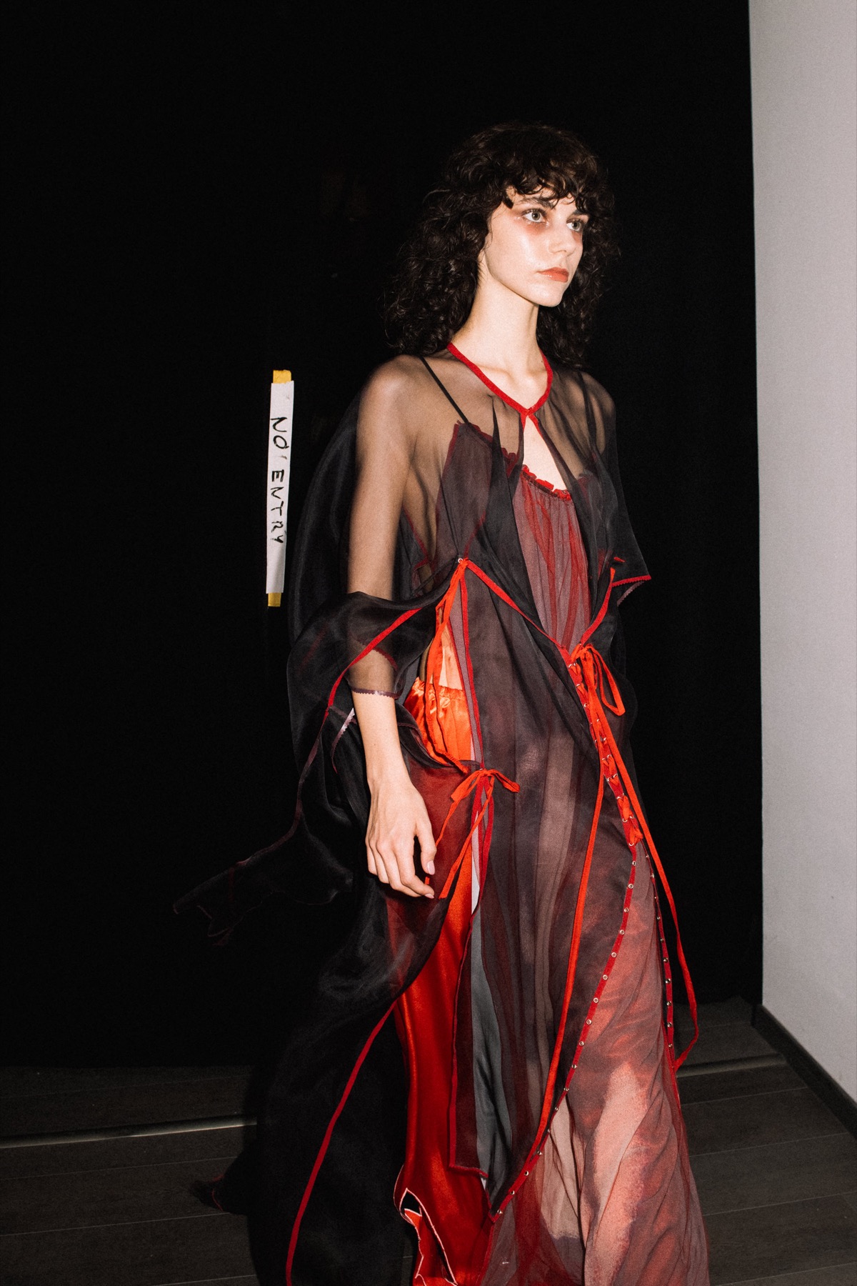 Mártusz Dorina — Runway photograph in a red and black sheer dress